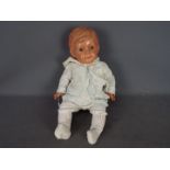 Ando Togoro - A large vintage Japanese celluloid jointed doll of a baby body.