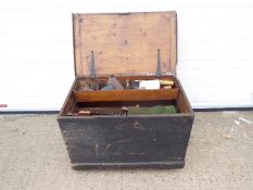 A carpenters tool chest containing a quantity of vintage tools.