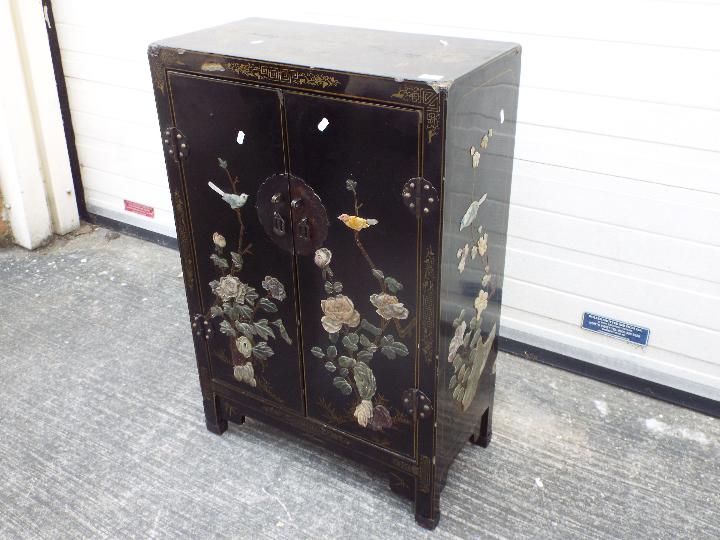A twin door black lacquered cabinet decorated with perching birds, - Image 2 of 7