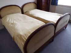 A pair of matched headboards and footboards one of which with original bed base,