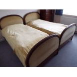 A pair of matched headboards and footboards one of which with original bed base,