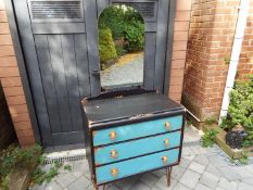 A mirror backed dressing table with three drawers, painted blue with gilded accents,