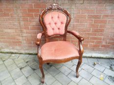 A button back armchair with red upholstery