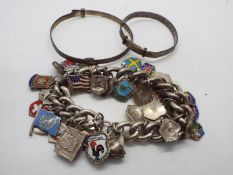 A white metal charm bracelet with a coll