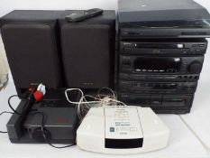 A Bose Wave Radio / CD music system, and Aiwa stereo system and turntable,