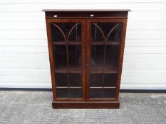 A twin door, astragal glazed bookcase, a