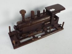 A carved wooden model of a steam locomot