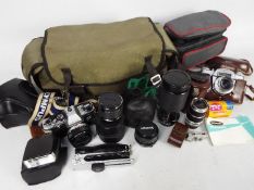 Photography - A collection of cameras and photographic equipment to include an Olympus OM10,
