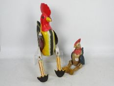 Two carved wood and painted, shelf sitting chickens, largest approximately 73 cm.