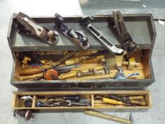 A vintage tool chest containing a quantity of vintage hand tools.
