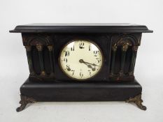 An early 20th century Gilbert faux slate mantel clock of architectural form.