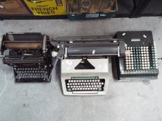Two vintage typewriters comprising an Underwood and an Olympia and a Comptometer mechanical