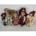 A collection of porcelain dressed dolls.