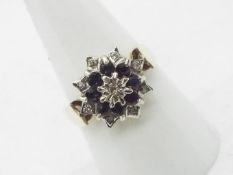 A 9ct yellow gold sapphire and white stone cluster ring, size Q, approximately 4.