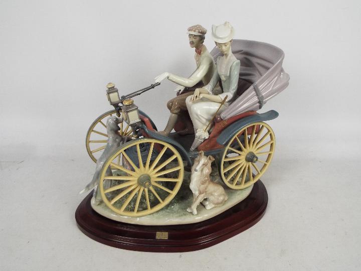 Lladro - A very large, limited edition porcelain group depicting a couple in an early motor vehicle,