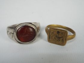 A yellow metal signet ring, size X, approximately 4.