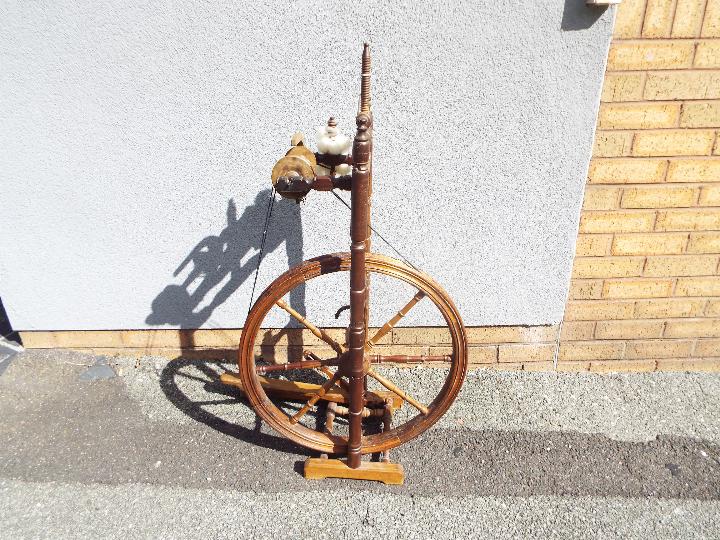 A late 19th or early 20th century spinning wheel, height 101 cm and wheel diameter 54 cm. - Image 3 of 3