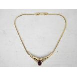 A Christian Dior gilt metal choker necklace with amethyst coloured glass stone,