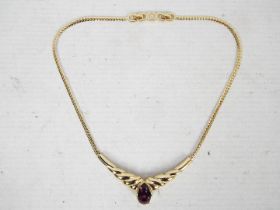 A Christian Dior gilt metal choker necklace with amethyst coloured glass stone,