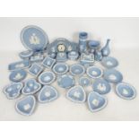 Wedgwood - A collection of blue Jasperware to include vases, mantel clock, trinket boxes,