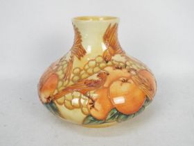 Moorcroft Pottery- a large squat vase tubelined and hand painted with finches and fruits,