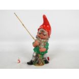 Garden Gnome, fishing Gnome - A plastic garden gnome with fishing line, hook and fish.