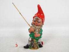 Garden Gnome, fishing Gnome - A plastic garden gnome with fishing line, hook and fish.