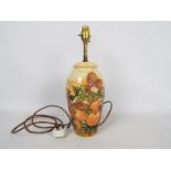 Moorcroft Pottery- a large table lamp tubelined and hand painted with finches and fruits,