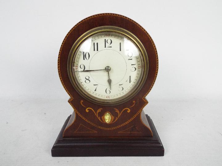 A French, inlaid mahogany, balloon shaped mantel clock, Arabic numerals to a white dial, with key,