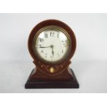 A French, inlaid mahogany, balloon shaped mantel clock, Arabic numerals to a white dial, with key,
