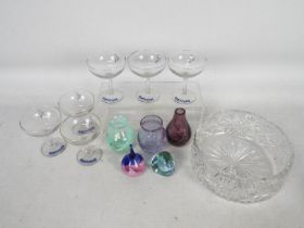 A collection of glassware to include Caithness vases and paperweights,