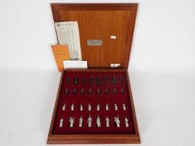 A cast pewter Camelot chess set by Royal Selangor in fitted chessboard box.