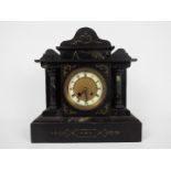 A black slate and green marble mantel clock of architectural form,