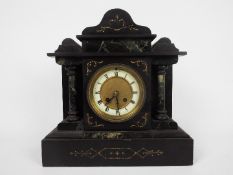 A black slate and green marble mantel clock of architectural form,
