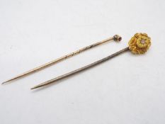 15ct gold - A yellow metal , stone set stick pin and one further example, stamped 15ct,