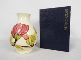 Moorcroft Pottery - a large vase of bulbous form tubelined and hand painted with pink magnolia on a