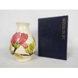 Moorcroft Pottery - a large vase of bulbous form tubelined and hand painted with pink magnolia on a