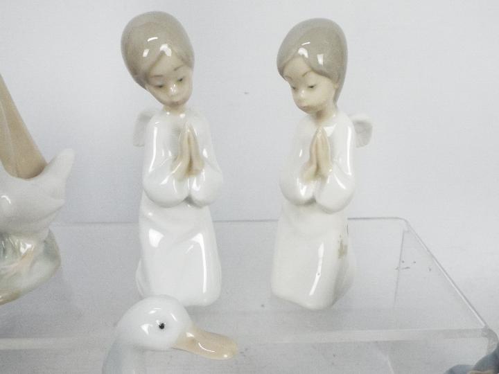 A collection of Lladro and Nao figures, largest approximately 24 cm (h). - Image 3 of 5