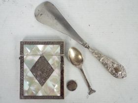 A mother of pearl and white metal card case, silver spoon, silver handled shoe horn and similar..
