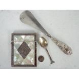 A mother of pearl and white metal card case, silver spoon, silver handled shoe horn and similar..