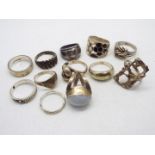 A collection of silver and white metal rings, various sizes.
