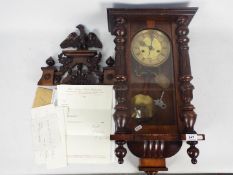 A small wall mounted Vienna style clock, walnut case with opening,