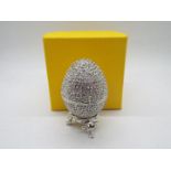 A crystal encrusted egg form trinket box with white enamel interior,