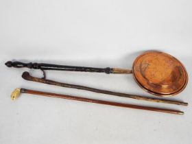 A late 19th century walking stick having a carved handle, likely tagua nut,