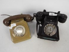 Two vintage dial telephones.