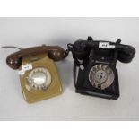 Two vintage dial telephones.