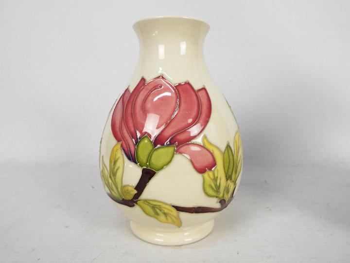Moorcroft Pottery - a large vase of bulbous form tubelined and hand painted with pink magnolia on a - Image 2 of 5