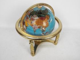 A brass and gemstone terrestrial globe, 32 cm (h).