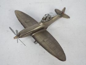 A novelty table lighter in the form of a Supermarine Spitfire Mk IX, 20 cm (l).