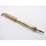A yellow metal slider propelling pencil by Sampson Mordan & Co, stamped with arrow mark for 10ct,